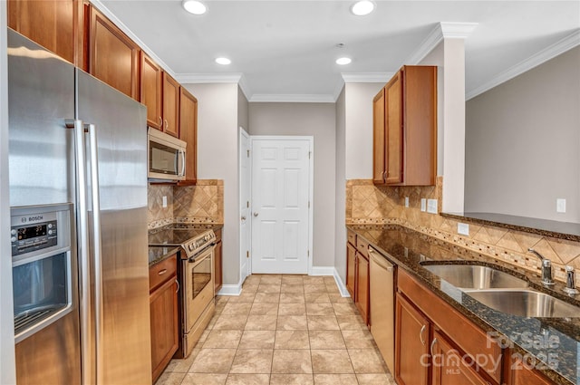 kitchen featuring dark stone countertops, decorative backsplash, appliances with stainless steel finishes, ornamental molding, and sink