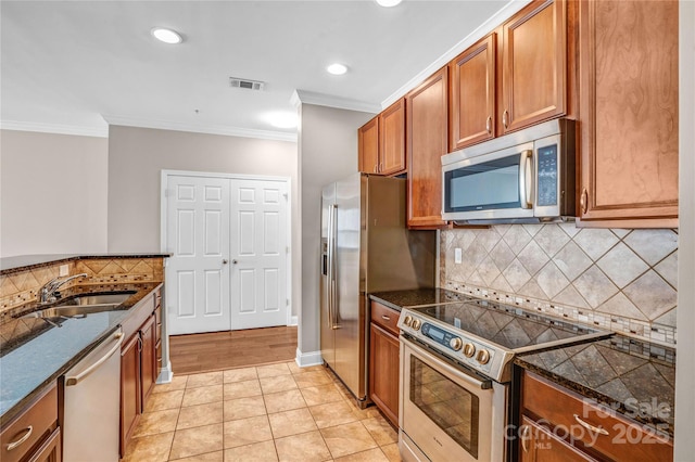 kitchen featuring stainless steel appliances, sink, light tile patterned flooring, backsplash, and crown molding