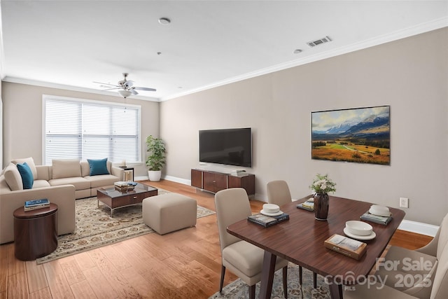 living room with ceiling fan, crown molding, and hardwood / wood-style flooring