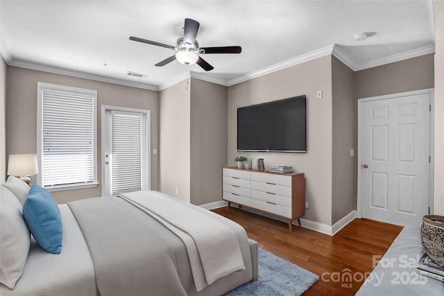 bedroom with ceiling fan, ornamental molding, and dark hardwood / wood-style floors