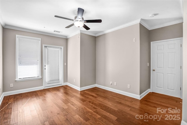 spare room with ceiling fan, crown molding, and hardwood / wood-style flooring