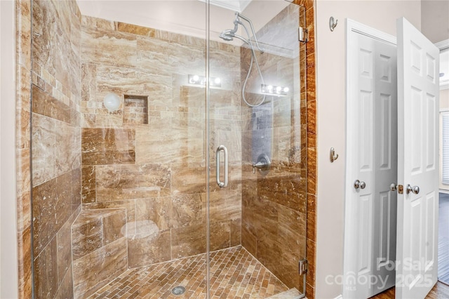 bathroom featuring a shower with door