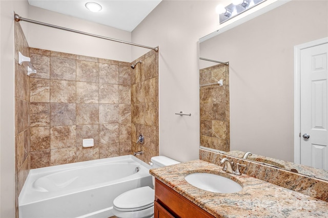 full bathroom with toilet, tiled shower / bath, and vanity