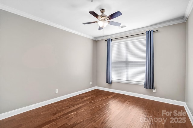 empty room with ornamental molding, ceiling fan, and wood-type flooring