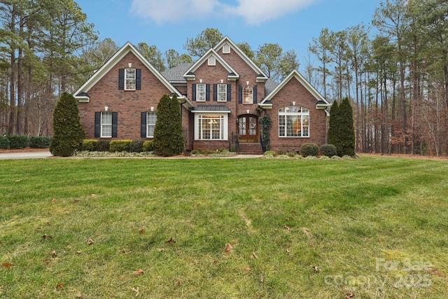 view of front of home with french doors and a front lawn