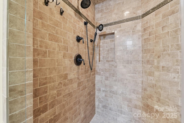 bathroom with tiled shower