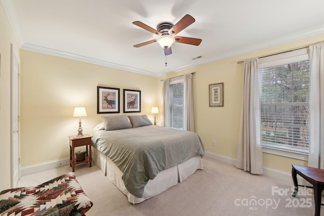 bedroom with multiple windows, ceiling fan, crown molding, and light carpet