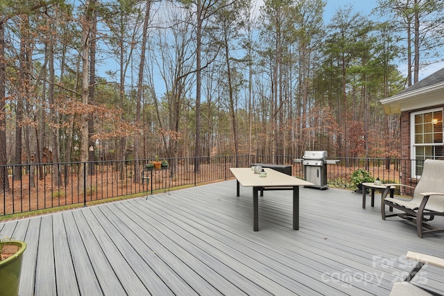 wooden terrace featuring a grill