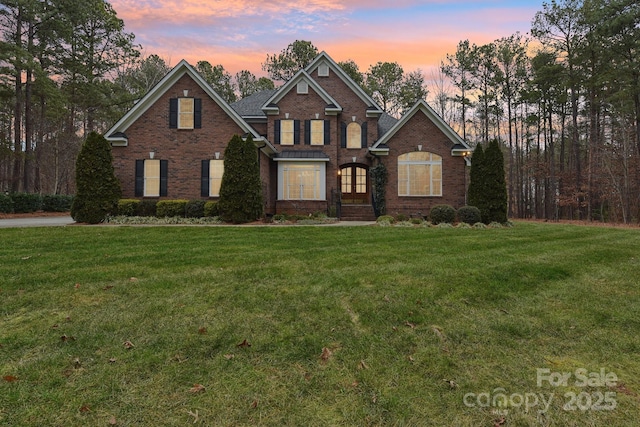 view of front of house with a yard and french doors