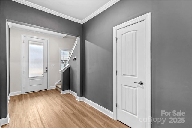 foyer featuring light hardwood / wood-style flooring and ornamental molding