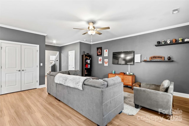 living room with ceiling fan, light hardwood / wood-style flooring, and crown molding