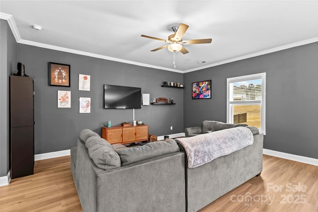 living room with ceiling fan, light hardwood / wood-style floors, and crown molding