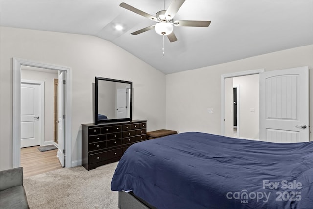 bedroom with light carpet, vaulted ceiling, and ceiling fan