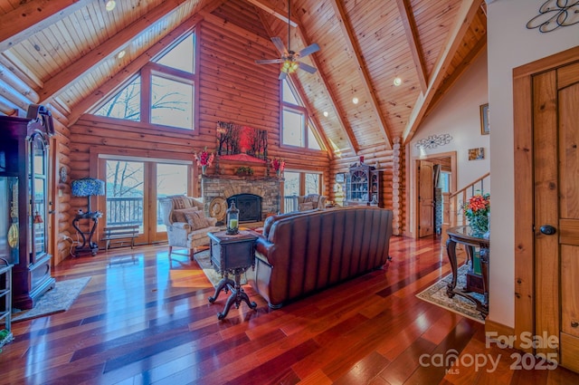 living room featuring high vaulted ceiling, wooden ceiling, wood-type flooring, and log walls