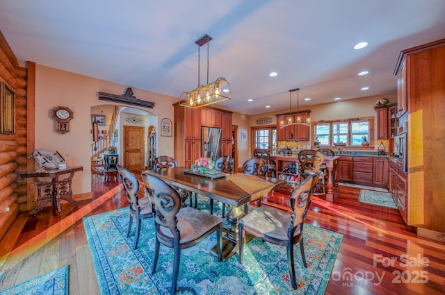 dining room featuring rustic walls and dark hardwood / wood-style flooring