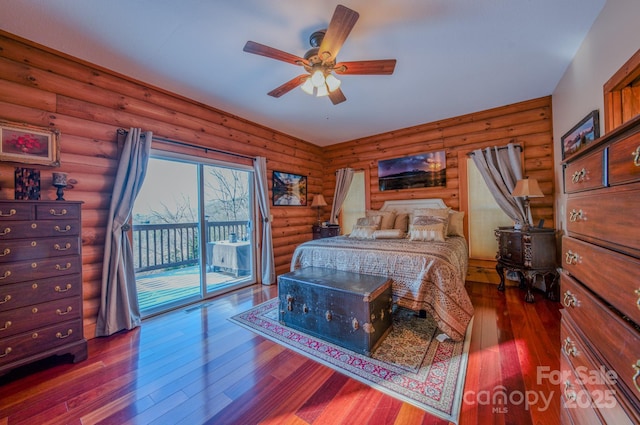 bedroom with ceiling fan, access to exterior, and log walls