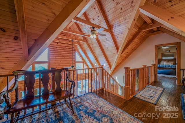 interior space featuring vaulted ceiling with beams, dark hardwood / wood-style floors, rustic walls, ceiling fan, and wooden ceiling