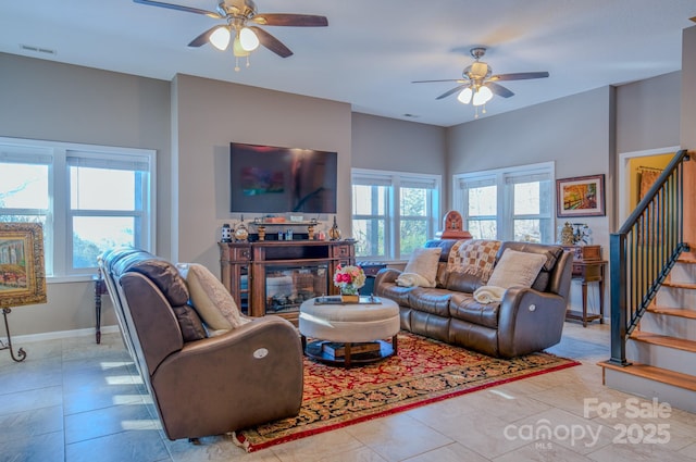 tiled living room featuring ceiling fan