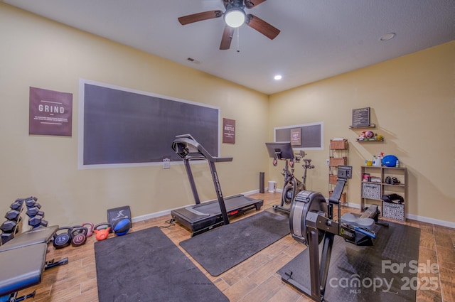 exercise room with hardwood / wood-style flooring and ceiling fan