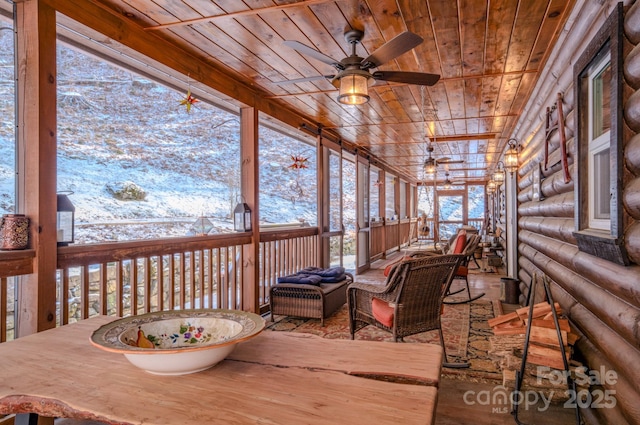 sunroom / solarium with ceiling fan and wood ceiling