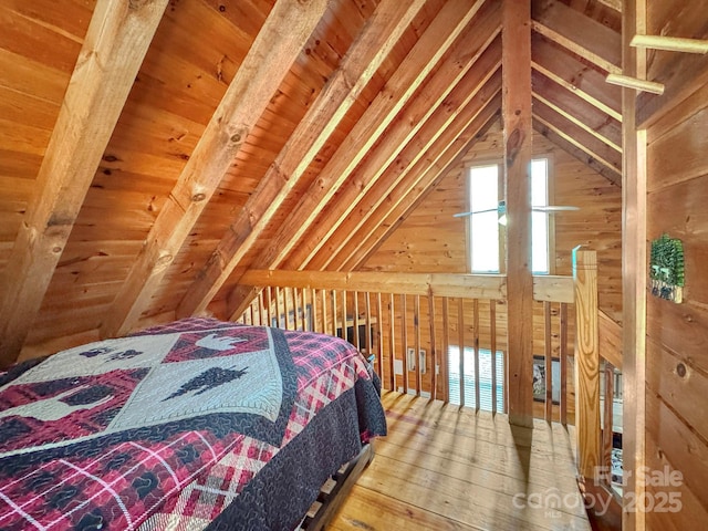 bedroom featuring beam ceiling, wooden walls, wooden ceiling, and wood-type flooring