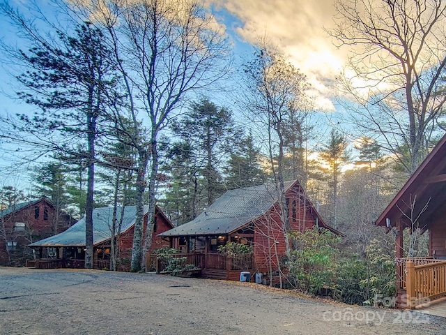 property exterior at dusk featuring a porch