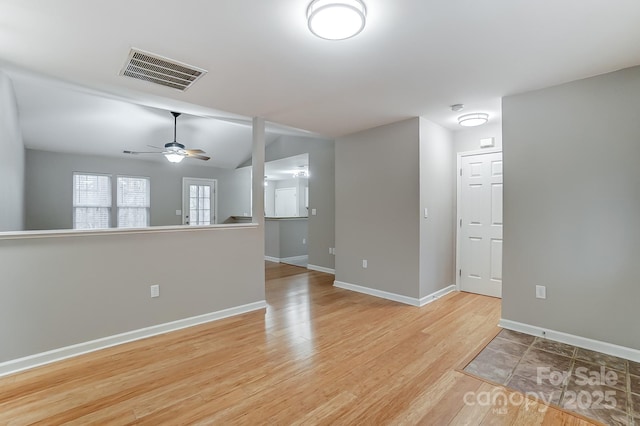 spare room featuring ceiling fan and light hardwood / wood-style flooring