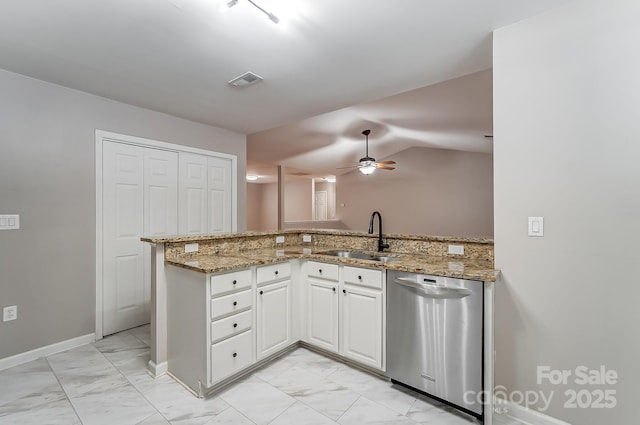 kitchen featuring dishwasher, light stone counters, white cabinetry, and sink