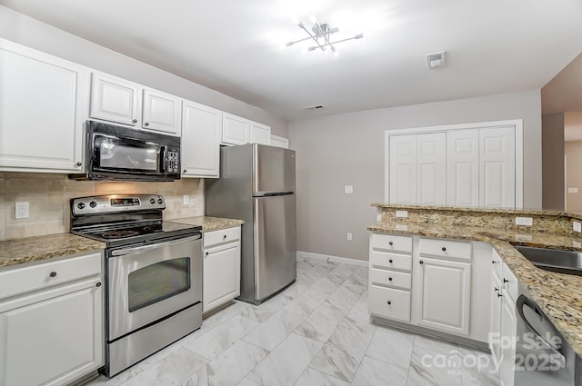 kitchen featuring backsplash, white cabinets, and appliances with stainless steel finishes