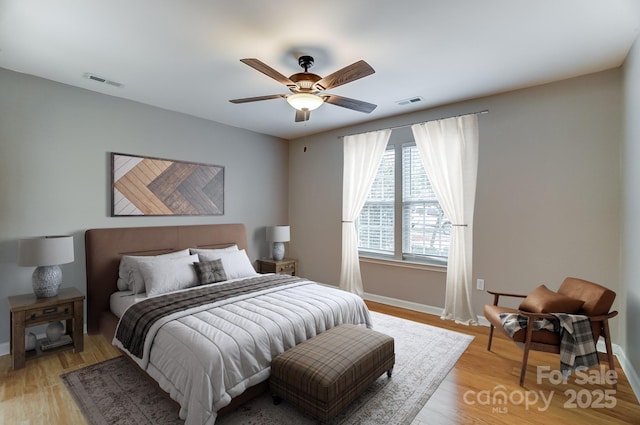 bedroom with ceiling fan and light hardwood / wood-style flooring