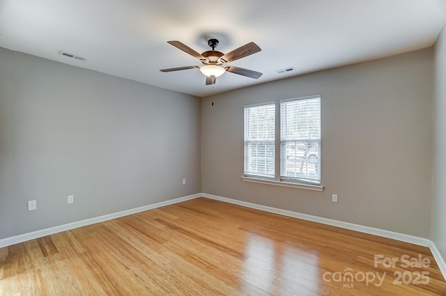 spare room with hardwood / wood-style flooring and ceiling fan