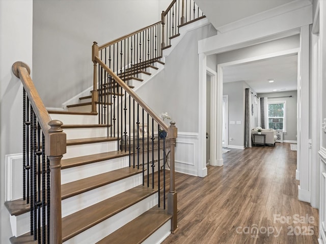 staircase with hardwood / wood-style flooring