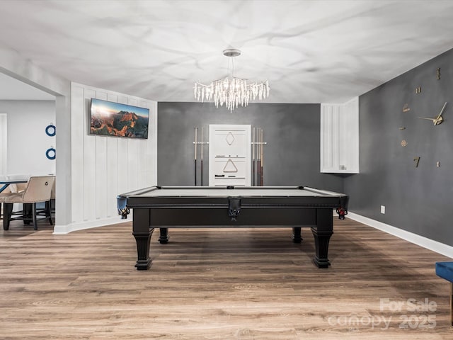 recreation room featuring pool table, a chandelier, and light hardwood / wood-style floors