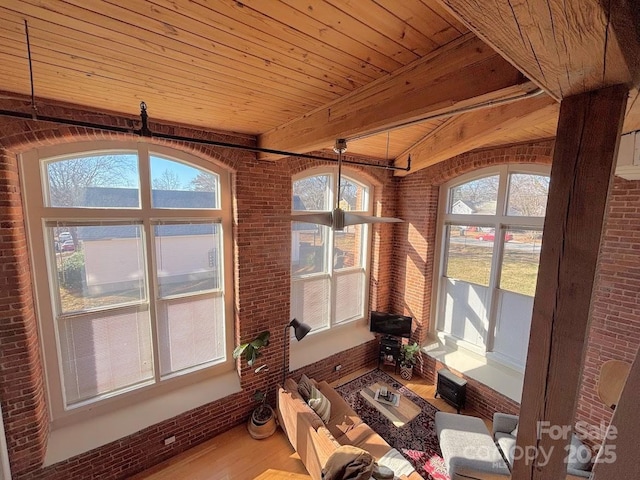 unfurnished sunroom with beamed ceiling and wood ceiling