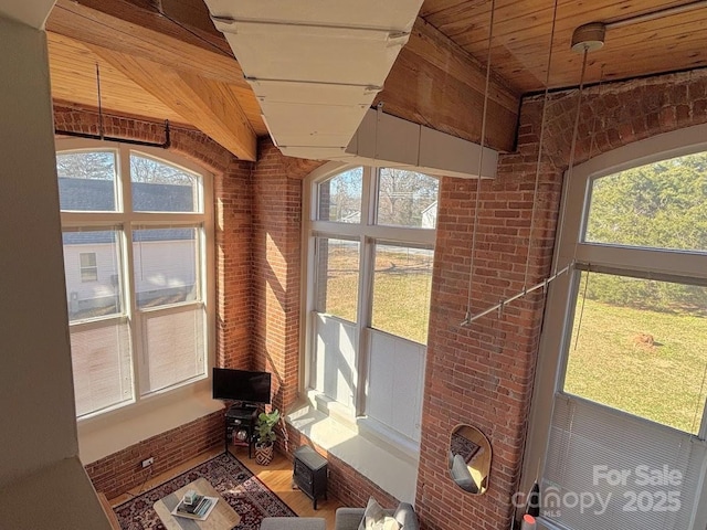 unfurnished sunroom with beamed ceiling and wood ceiling