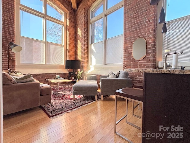201 S Hoskins Rd Unit 136, Charlotte, NC 28208 - living area with light wood finished floors and brick wall