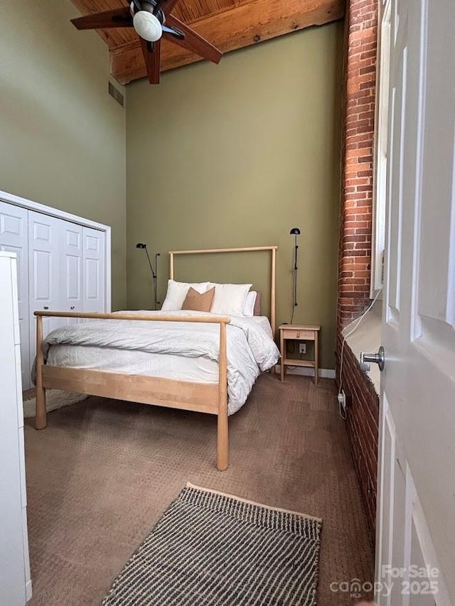 201 S Hoskins Rd Unit 136, Charlotte, NC 28208 - bedroom featuring a wood ceiling with exposed beams, carpet floors, a high ceiling, and ceiling fan
