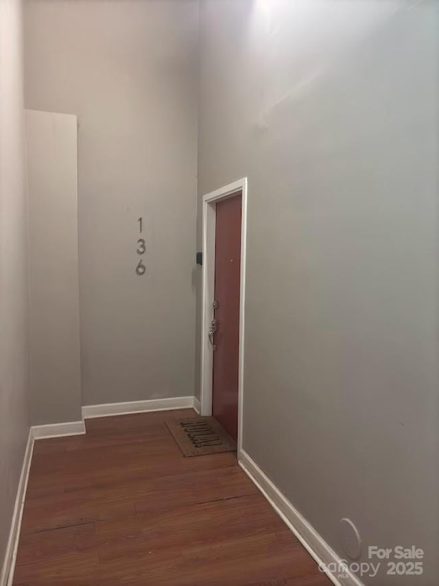 hallway with dark hardwood / wood-style flooring