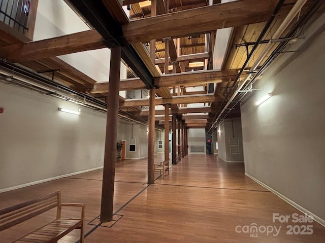 interior space featuring hardwood / wood-style floors and a towering ceiling