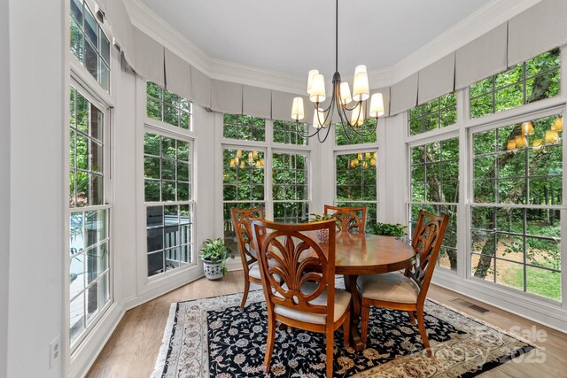 sunroom with a notable chandelier