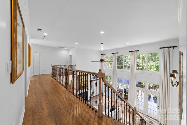 hall featuring hardwood / wood-style flooring, ornamental molding, and french doors