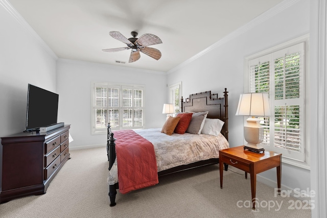 carpeted bedroom featuring ceiling fan and crown molding