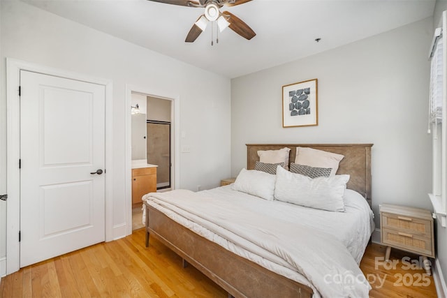 bedroom featuring ceiling fan, light hardwood / wood-style floors, and ensuite bath