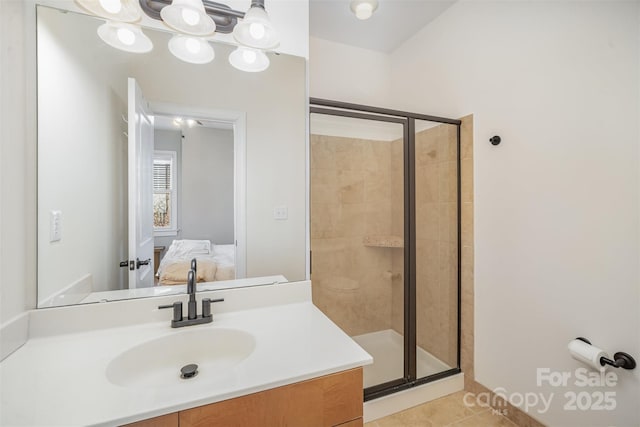 bathroom featuring vanity, tile patterned flooring, and walk in shower