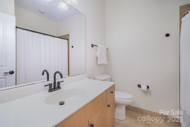 bathroom with toilet, tile patterned flooring, and vanity