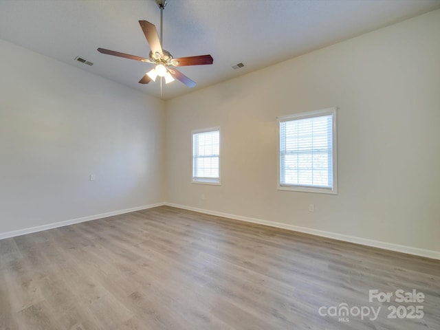 empty room featuring ceiling fan and light wood-type flooring