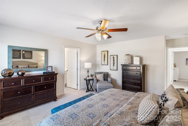 bedroom with ceiling fan and light carpet