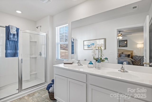 bathroom with ceiling fan, a shower with shower door, and vanity