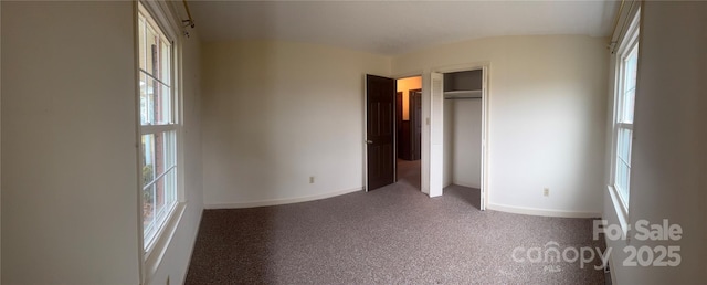 unfurnished bedroom featuring carpet and a closet