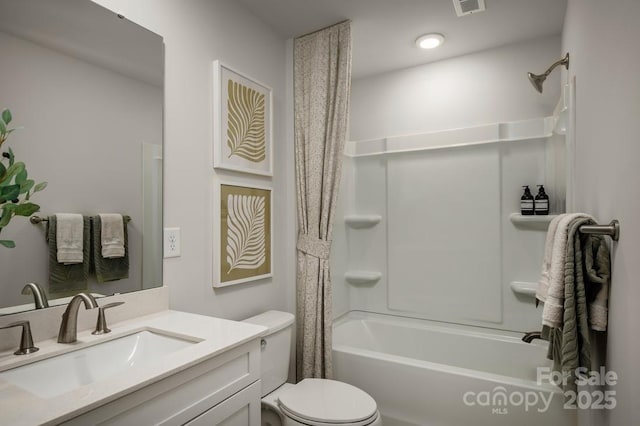 full bathroom featuring toilet, vanity, and shower / tub combo